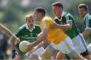 25 June 2016; Sean Burke of Antrim is tackled by Paul Hannon of Limerick during the All-Ireland Football Senior Championship 1B qualifier game between Antrim and Limerick at Corrigan Park in Belfast. Photo by Ramsey Cardy/Sportsfile