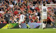4 August 2010; Manchester United's Michael Owen shoots to score his side's second goal despite the attepts of Airtricity League XI's Gavin Peers, 4, and Ken Oman. Friendly Match, Airtricity League XI v Manchester United, Aviva Stadium, Lansdowne Road, Dublin. Photo by Sportsfile