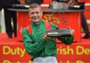 25 June 2016; Pat Smullen celebrates with the trophy after winning the Dubai Duty Free Irish Derby on Harzand at the Curragh Racecourse in the Curragh, Co. Kildare. Photo by Cody Glenn/Sportsfile