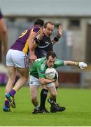 25 June 2016; Daithi Waters of Wexford appears to be obstructed by referee Eddie Kinsella as he attempts to tackle Ruairi Corrigan of Fermanagh during their GAA Football All-Ireland Senior Championship Round 1B match at Innovate Wexford Park in Wexford. Photo by Diarmuid Greene/Sportsfile