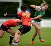 25 June 2016; Aoife Doyle of Ireland is tackled by Liu Xiaoqian, left, and Liu Yan, right, of China during the World Rugby Women's Sevens Olympic Repechage Pool C match between Ireland and China at UCD Sports Centre in Belfield, Dublin. Photo by Seb Daly/Sportsfile