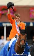 6 August 2010; Harrie Smolders, Netherlands, on Exquis Walnut De Muze, celebrates with the Aga Khan trophy following Netherlands victory in the Meydan FEI Nations Cup - Failte Ireland Dublin Horse Show 2010. RDS, Ballsbridge, Dublin. Picture credit: Stephen McCarthy / SPORTSFILE