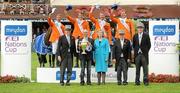 6 August 2010; Netherlands Chef d'Equipe Rob Ehrens is presented with the Aga Khan trophy by President of Ireland Mary McAleese, as Netherlands riders, from left, Eric van der Vleuten, Harrie Smolders, Marc Houtzager and Jur Vrieling celebrate following their victory in the Meydan FEI Nations Cup - Failte Ireland Dublin Horse Show 2010. RDS, Ballsbridge, Dublin. Picture credit: Stephen McCarthy / SPORTSFILE