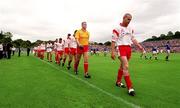 8 July 2001; Tyrone captain Sean Teague leads his side during the parade prior to the Bank of Ireland Ulster Senior Football Championship Final match between Tyrone and Cavan at St Tiernach's Park in Clones, Monaghan. Photo by Damien Eagers/Sportsfile