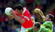 15 July 2001; Setanta O'hAilpin of Cork is tackled by Paddy Kelly and Fergal Griffin, right, of Kerry. during the Munster Minor Football Championship Final match between Cork and Kerry in Pairc Ui Chaoimh in Cork. Photo by Pat Murphy/Sportsfile