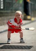 15 July 2001; Odhran McKeever, son of Derry hurler Kieran McKeever, plays with his hurley prior to the Guinness Ulster Senior Hurling Championship Final match between Derry and Down at Casement Park in Belfast. Photo by Aoife Rice/Sportsfile