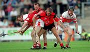 15 July 2001; John O'Dwyer of Derry in action against Jerome Trainor of Down during the Guinness Ulster Senior Hurling Championship Final match between Derry and Down at Casement Park in Belfast. Photo by Aoife Rice/Sportsfile