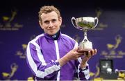 26 June 2016; Jockey Ryan Moore with the trophy after winning the Sea The Stars Pretty Polly Stakes on Minding at the Curragh Racecourse in the Curragh, Co. Kildare. Photo by Cody Glenn/Sportsfile