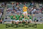 26 June 2016; Paddy O'Rourke of Meath jumps the bench as the teams come for the traditional team picture before the Leinster GAA Football Senior Championship Semi-Final match between Dublin and Meath at Croke Park in Dublin. Photo by Oliver McVeigh/Sportsfile