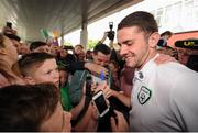 27 June 2016; Robbie Brady of Republic of Ireland poses for a photo with a supporter during their return from UEFA Euro 2016 in France at Dublin Airport, Dublin. Photo by Seb Daly/Sportsfile