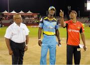29 June 2016;  Dwayne Bravo (R) of Trinbago Knight Riders toss the coin as Darren Sammy of St. Lucia Zouks (C) and match referee Hayden Bruce (L) look on at the start of Match 1 of the Hero Caribbean Premier League between Trinbago Knight Riders and St Lucia Zouks at the Queen's Park Oval in Port of Spain, Trinidad. Photo by: Randy Brooks/Sportsfile