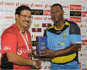 29 June 2016; Johnson Charles, left, of St Lucia Zouks receives the player of the match prize from Venky Mysore, left, managing director of Trinbago Knight Riders at the end of Match 1 of the Hero Caribbean Premier League between Trinbago Knight Riders and St Lucia Zouks at the Queen's Park Oval in Port of Spain, Trinidad. Photo by Randy Brooks/Sportsfile