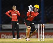 29 June 2016; Umar Akmal (R) of Trinbago Knight Riders attemps to run out Andre Fletcher of St Lucia Zouks as Sunil Narine (L) watch during Match 1 of the Hero Caribbean Premier League between Trinbago Knight Riders and St Lucia Zouks at the Queen's Park Oval in Port of Spain, Trinidad. Photo by Randy Brooks/Sportsfile