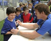 13 August 2010; Brian O'Driscoll signs an autograph for five-year-old Conor Heerey, from Churchtown, Dublin, at the Centra Leinster Rugby Summer Camps 2010. Donnybrook, Dublin. Picture credit: Ray McManus / SPORTSFILE