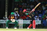 30 June 2016; Devon Thomas of St Kitts & Nevis Patriots hits six as Anthony Bramble of Guyana Amazon Warriors looks on during Match 2 of the Hero Caribbean Premier League between St Kitts & Nevis Patriots and Guyana Amazon Warriors at Warner Park in Basseterre, St Kitts. Photo by: Ashley Allen/Sportsfile