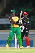 30 June 2016; Dwayne Smith of Guyana Amazon Warriors hits a six en route to his half century as Devon Thomas of St Kitts & Nevis Patriots looks on during Match 2 of the Hero Caribbean Premier League between St Kitts & Nevis Patriots and Guyana Amazon Warriors at Warner Park in Basseterre, St Kitts. Photo by: Ashley Allen/Sportsfile