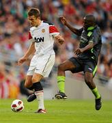 4 August 2010; Michael Carrick, Manchester United, in action against Joseph Ndo, Airtricity League XI. Friendly Match, Airtricity League XI v Manchester United, Aviva Stadium, Lansdowne Road, Dublin. Picture credit: Stephen McCarthy / SPORTSFILE