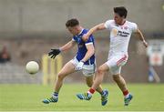 3 July 2016; Dara McVeety of Cavan is tackled by Mattie Donnelly of Tyrone during the Ulster GAA Football Senior Championship Semi-Final Replay between Tyrone and Cavan at St Tiemach's Park in Clones, Co Monaghan. Photo by Ramsey Cardy/Sportsfile