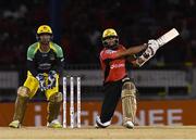 4 July 2016; Hashim Amla, right, of Trinbago Knight Riders hits a 6 as keeper Kumar Sangakkara of Jamaica Tallawahs looks on during Match 7 of the Hero Caribbean Premier League between Trinbago Knight Riders and Jamaica Tallawahs at Queen's Park Oval, in Port of Spain, Trinidad. Photo by Randy Brooks/Sportsfile