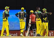 4 July 2016; Hashim Amla, centre, of Trinbago Knight Riders walks off the field after being caught out by Kumar Sangakkara off bowler Kesrick Williams of Jamaica Tallawahs during Match 7 of the Hero Caribbean Premier League between Trinbago Knight Riders and Jamaica Tallawahs at Queen's Park Oval, in Port of Spain, Trinidad. Photo by Randy Brooks/Sportsfile