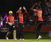 4 July 2016; Umar Akmal, Sunil Narine and Sulieman Benn of Trinbago Knight Riders celebrate the dismissal of Kumar Sangakkara of Jamaica Tallawahs during Match 7 of the Hero Caribbean Premier League between Trinbago Knight Riders and Jamaica Tallawahs at Queen's Park Oval, in Port of Spain, Trinidad. Photo by Randy Brooks/Sportsfile