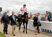 21 August 2010; Pathfork, with Fran Berry up, is led to the parade ring by owners Tom and Bonnie Hamilton,  after winning The Galileo European Breeders Fund Futurity Stakes. Horse Racing, Curragh Racecourse, Co. Kildare. Picture credit: Barry Cregg / SPORTSFILE