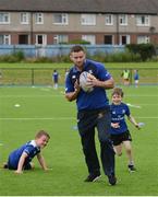 6 July 2016; Leinster rugby player Fergus McFadden in action against Sean Rooney, left, age 7 from Ranelagh, and Colm O'Donovan, aged 7, from Donnybrook, during the Bank of Ireland Leinster Rugby Camp at Donnybrook Stadium, Donnybrook, Dublin. Photo by Piaras Ó Mídheach/Sportsfile