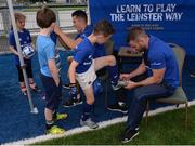6 July 2016; Leinster rugby player Fergus McFadden signs an autograph for Ethan Connor aged 8, from Ranelagh, in action during the Bank of Ireland Leinster Rugby Camp at Donnybrook Stadium, Donnybrook, Dublin. Photo by Piaras Ó Mídheach/Sportsfile