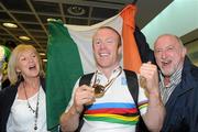 24 August 2010; Mark Rohan, from Athlone, Co. Westmeath, with his mother Carmel and father Denis, on his return home after securing Ireland's first ever Paracycling World Championship Gold Medal by winning the H1 Handcycling Road Race in Baie-Comeau Canada. Dublin Airport, Dublin. Picture credit: Brian Lawless / SPORTSFILE