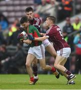 10 July 2016; Oisin McLaughlin of Mayo is tackled by Sean Mulkerrin, left, and Adam Quirke of Galway during the Electric Ireland Connacht GAA Football Minor Championship Final between Galway and Mayo at Pearse Stadium in Galway. Photo by Ramsey Cardy/Sportsfile