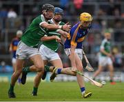 10 July 2016; Mark Kehoe of Tipperary in action against David Wolfe, 13, and Jerome Boylan of Limerick during the Electric Ireland Munster GAA Minor Hurling Championship Final match between Limerick and Tipperary at the Gaelic Grounds in Limerick Photo by Ray McManus/Sportsfile