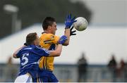 10 July 2016; Jamie Malone of Clare in action against Stephen Attride of Laois during the GAA Football All-Ireland Senior Championship - Round 2A match between Clare and Laois at Cusack Park in Ennis, Clare. Photo by Piaras Ó Mídheach/Sportsfile