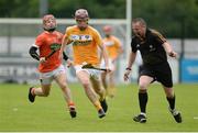10 July 16; Eoghan Campbell of Antrim having to side step Referee Eamon Hassan and Cathal Carvill of Armagh during the Ulster GAA Hurling Senior Championship Final match between Antrim and Armagh at Derry GAA Centre of Excellence in Owenbeg, Derry. Photo by Oliver McVeigh/Sportsfile