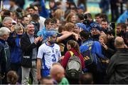 10 July 2016; Colin Dunford of Waterford makes his way back to the dressing room as Tipperary players and supporters celebrate after the Munster GAA Hurling Senior Championship Final match between Tipperary and Waterford at the Gaelic Grounds in Limerick.  Photo by Ray McManus/Sportsfile
