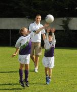 27 August 2010; Over 80,000 children have been taking part in over 1,000 Vhi GAA Cúl Camps in 4 different countries including Ireland, UK, Canada and USA this summer. Down captain Ambrose Rodgers is one of 22 ambassadors that have been visiting the Vhi GAA Cúl Camps throughout the summer, giving tips to children on how to improve their game and training the lucky children selected to take part in the Vhi Cúl Day Out in September and today Ambrose officially closed the Vhi GAA Cúl Camps at Kilmacud Crokes GAA Club. Down captain Ambrose Rodgers watches Paraic Moran, age 8, from Stillorgan, Co. Dublin, contests a high ball with, David Crowe, age 7, from Stillorgan, Co. Dublin, right. Kilmacud Crokes GAA Club, Glenalbyn, Stillorgan, Co. Dublin. Picture credit: Dáire Brennan / SPORTSFILE