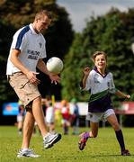 27 August 2010; Over 80,000 children have been taking part in over 1,000 Vhi GAA Cúl Camps in 4 different countries including Ireland, UK, Canada and USA this summer. Down captain Ambrose Rodgers is one of 22 ambassadors that have been visiting the Vhi GAA Cúl Camps throughout the summer, giving tips to children on how to improve their game and training the lucky children selected to take part in the Vhi Cúl Day Out in September and today Ambrose officially closed the Vhi GAA Cúl Camps at Kilmacud Crokes GAA Club. Down captain Ambrose Rodgers maintains possession despite Anna Geraghty, age 9, from Blackrock, Co. Dublin, during the Vhi GAA Cúl Camps at Kilmacud Crokes GAA Club. Kilmacud Crokes GAA Club, Glenalbyn, Stillorgan, Co. Dublin. Picture credit: Stephen McCarthy / SPORTSFILE