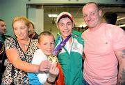27 August 2010; Youth Olympics Gold Medallist Ryan Burnett, Holy Family Boxing Club, Belfast, with his parents Brian and Bernadette and brother Eoghan, aged 12, on his arrival back to Ireland after winner gold in the Light Fly weight, 48kg, category. Dublin Airport, Dublin. Photo by Sportsfile