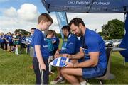 13 July 2016; Leinster's Niall Morris signs an autograph for Joseph Walsh during the Bank of Ireland Leinster Rugby Summer Camp - Greystones RFC at Greystones RFC in Greystones, Co Wicklow. Photo by Matt Browne/Sportsfile