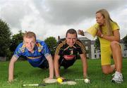 25 August 2010; Hurling rivals from Kilkenny and Tipperary go head to head to launch the Aviva ‘Have You Got Balls Challenge’. Along with Aviva, All Ireland Hurlers, Lar Corbett from Tipperary and Kilkenny’s Eddie Brennan, are challenging men to put their sports balls to the test against the sports stars while raising money for the Irish Heart Foundation. Tipperary hurler Lar Corbett, left, and Kilkenny hurler Eddie Brennan are pictured with Fitsquad trainer Kate Ryan at the launch of Aviva Health Insurance Benefit with Fit Squad. Durrow, Co. Laois. Picture credit: Brian Lawless / SPORTSFILE
