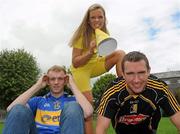 25 August 2010; Hurling rivals from Kilkenny and Tipperary go head to head to launch the Aviva ‘Have You Got Balls Challenge’. Along with Aviva, All Ireland Hurlers, Lar Corbett from Tipperary and Kilkenny’s Eddie Brennan, are challenging men to put their sports balls to the test against the sports stars while raising money for the Irish Heart Foundation. Tipperary hurler Lar Corbett, left, and Kilkenny hurler Eddie Brennan are pictured with Fitsquad trainer Kate Ryan at the launch of Aviva Health Insurance Benefit with Fit Squad. Durrow, Co. Laois. Picture credit: Brian Lawless / SPORTSFILE