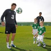 31 August 2010; Republic of Ireland captain Robbie Keane shows off his skills to Nathan Howard, age 4, and his sister Alex, age 7, from Ashbourne, Co. Meath, at the announcement today by 3, Ireland’s largest high speed network, and the Football Association of Ireland of an exciting opportunity for one lucky young football fan to be the next mascot when the senior National team play Andorra in the Aviva Stadium on September 7th 2010. The winner will have the chance of a lifetime to lead the team onto the pitch with the captain, Robbie Keane. All entrants must be 7-11 years old. To nominate a mascot, visit www.three.ie and submit 50 words on why your nominated child would make a great mascot for the Irish National football team. The winner will be announced after the team training session on Monday 6th September and the prize will also include overnight accommodation and a new 3Pay phone from 3 for the nominator. Gannon Park, Malahide, Co. Dublin. Picture credit: David Maher / SPORTSFILE
