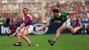 1 September 1996; Larry O'Gorman of Wexford in action against Mark Foley of Limerick during the Guinness All-Ireland Senior Hurling Championship Final match between Wexford and Limerick at Croke Park in Dublin. Photo by Ray McManus/Sportsfile