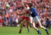 22 July 2001; Enda Muldoon of Derry in action against Thomas Prior of Cavan during the Bank of Ireland All-Ireland Senior Football Championship Qualifier, round 4, match between Derry and Cavan at St. Tiernach's Park in Clones, Monaghan. Photo by Damien Eagers/Sportsfile