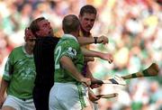 29 July 2001; Referee Michael Wadding separates Nicky Lambert of Wexford and Stephen McDonagh of Limerick during the Guinness All-Ireland Senior Hurling Championship Quarter-Final match between Wexford and Limerick at Croke Park in Dublin. Photo by Damien Eagers/Sportsfile