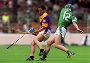 29 July 2001; Adrian Fenlon of Wexford in action against Mike O'Brien of Limerick during the Guinness All-Ireland Senior Hurling Championship Quarter-Final match between Wexford and Limerick at Croke Park in Dublin. Photo by Damien Eagers/Sportsfile