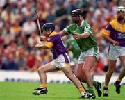 29 July 2001; Liam Dunne of Wexford in action against Brian Begley of Limerick during the Guinness All-Ireland Senior Hurling Championship Quarter-Final match between Wexford and Limerick at Croke Park in Dublin. Photo by Damien Eagers/Sportsfile