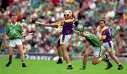 29 July 2001; Declan Ruth of Wexford clears downfield from Mike O'Brien of Limerick during the Guinness All-Ireland Senior Hurling Championship Quarter-Final match between Wexford and Limerick at Croke Park in Dublin. Photo by Damien Eagers/Sportsfile