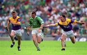 29 July 2001; Mark Foley of Limerick attempts to get away from Adrian Fenlon of Wexford during the Guinness All-Ireland Senior Hurling Championship Quarter-Final match between Wexford and Limerick at Croke Park in Dublin. Photo by Damien Eagers/Sportsfile