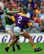 29 July 2001; Eoin O'Neill of Limerick is fouled by Rory Mallon of Wexford which resulted in a Limerick goal during the Guinness All-Ireland Senior Hurling Championship Quarter-Final match between Wexford and Limerick at Croke Park in Dublin. Photo by Damien Eagers/Sportsfile