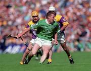 29 July 2001; Mark Foley of Limerick is tackled by Michael Jordan of Wexford during the Guinness All-Ireland Senior Hurling Championship Quarter-Final match between Wexford and Limerick at Croke Park in Dublin. Photo by Damien Eagers/Sportsfile